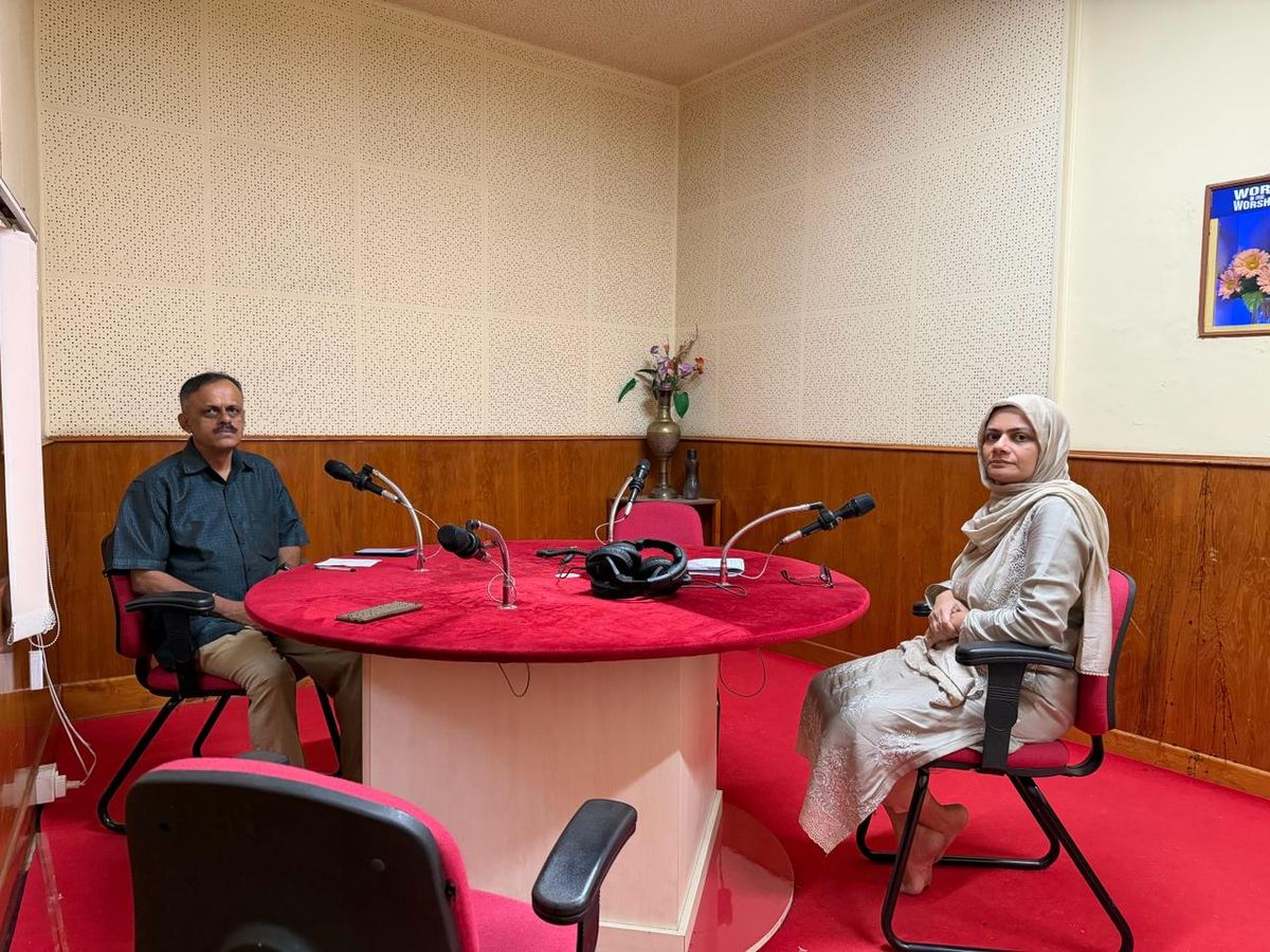 Dr. Mariam Anjum during a press interview with microphones at a studio